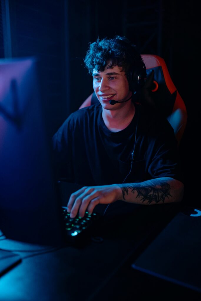 A Man in Black Shirt Playing Video Games on Computer